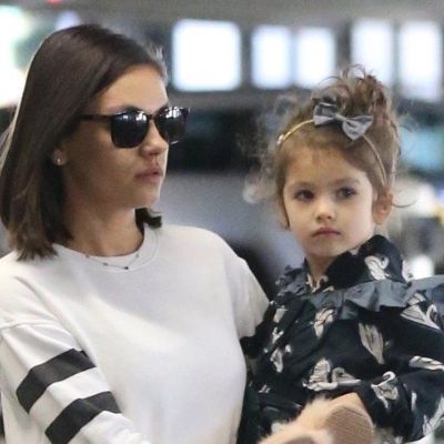 Mila is going somewhere carrying Wyatt.